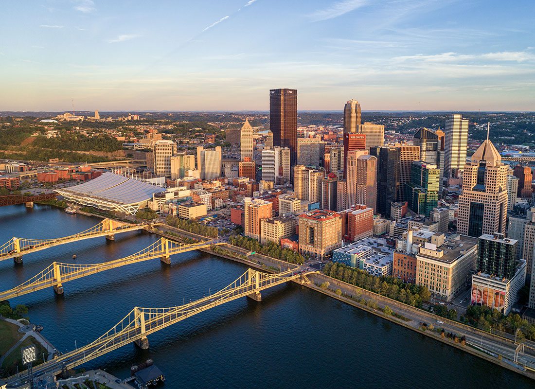 Contact - Aerial Landscape View of Pittsburg, Pennsylvania Skyline and Many Bridges at Dusk