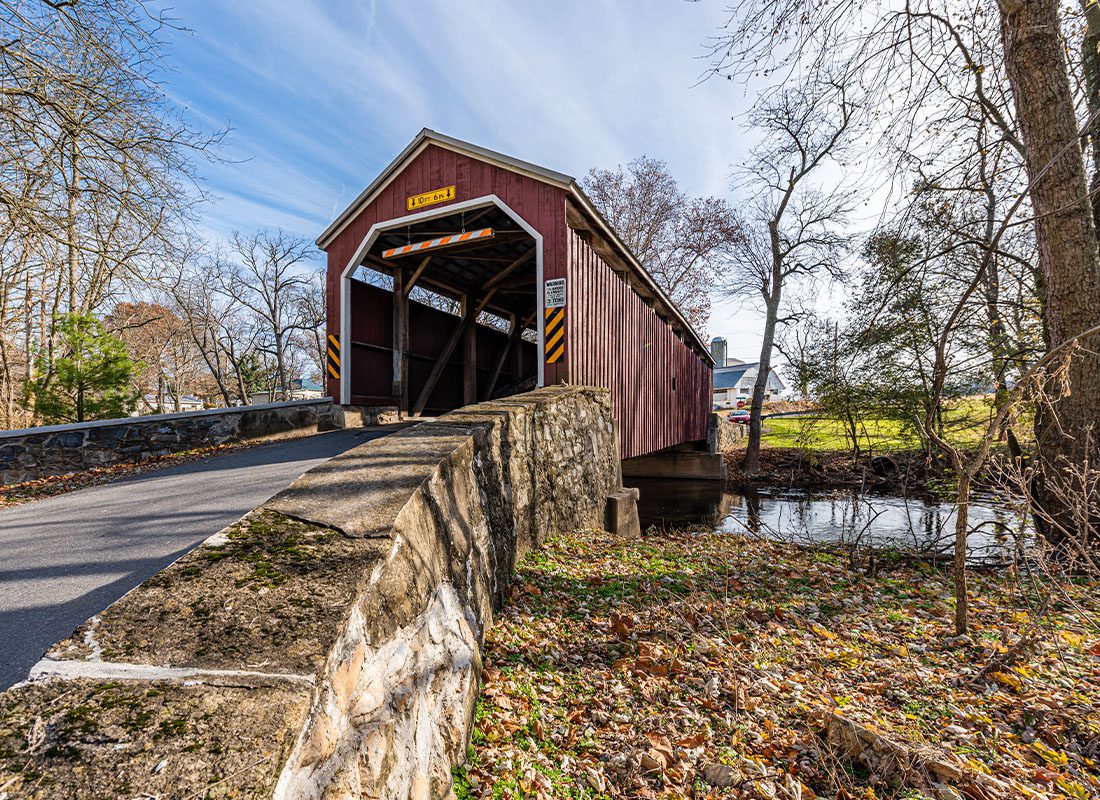 About Our Agency - Rural Landscape of Covered Bridge in Pennsylvania Forest